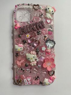 an iphone case with hello kitty and other items on it