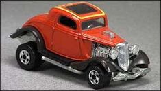 an orange toy car with chrome rims on it's tires and hood is shown