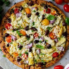 a pizza sitting on top of a table covered in toppings