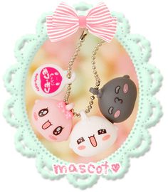 two key chains with cats on them are attached to a chain that says mascotv