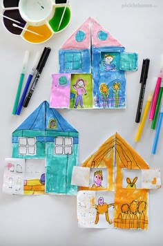 an image of some crafts that are in the shape of houses and children's drawings