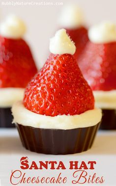 chocolate cupcakes topped with strawberries and white frosting in santa hat hats