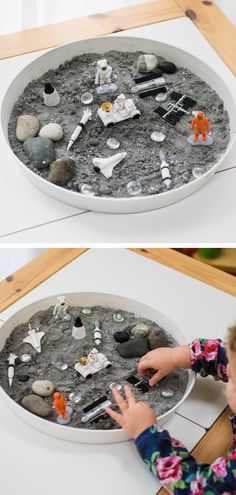 this is an image of a child playing with sand and rocks