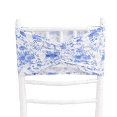 a white chair with blue and white flowers on it