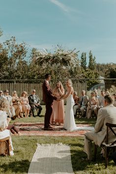 a bride and groom standing at the end of their wedding ceremony