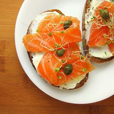 two pieces of bread topped with salmon and cream cheese