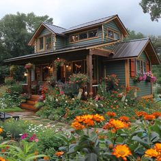 a green house with lots of flowers around it