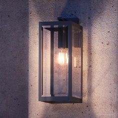 an outdoor wall light on the side of a building with no one in it yet