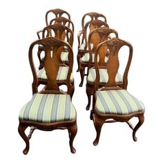 six chairs with striped upholstered seats on each side and one chair in the middle