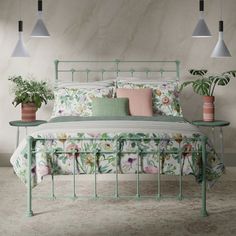 a bed with flowers and plants on the headboard, in a room with white walls