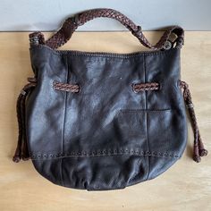 This soft, brown leather SAK purse is in good condition. There is minimal wear to the leather, there are a few nicks on the leather pull straps. Also on the front is a small yellow spot. This is a preowned bag and there could be a small defect that I missed. As you can see in the last 2 pics there is ink stain on the lining. Please look at the pictures for more details.  Thanks for your interest. Measurements are approximate  It is about 15" wide laying flat Depth 13" Bottom diameter 6"  1.6 lbs #618 Brown Textured Leather Hobo Bag, Brown Hobo Shoulder Bag With Braided Handles, Brown Textured Leather Hobo Bag With Double Handles, Brown Leather Bag With Braided Handles, Brown Textured Leather Hobo Shoulder Bag, Casual Brown Leather Hobo Bag, Sak Purses, Brown Leather Bag, Ink Stain