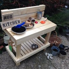 a potting bench made out of pallet wood with pots and pans on it