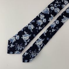 This handmade floral tie is an excellent accessory for weddings, parties, proms - an excellent gift for anyone who enjoys dressing-up dapper! Style: slim/narrow Fabric: 50% cotton / 50% linen Approx. Measurements: (W) 2.4 in. x (L) 58 in. Care: Dry clean only Elegant Floral Print Suit And Tie Accessories For Wedding, Elegant Adjustable Suit And Tie Accessories With Floral Print, Elegant Adjustable Floral Print Suit And Tie Accessories, Elegant Floral Print Adjustable Suit And Tie Accessories, Blue Standard Tie For Wedding, Blue Summer Wedding Ties, Blue Ties For Wedding Neckwear, Fitted Blue Floral Suit And Tie Accessories, Blue Wedding Neckwear With Ties