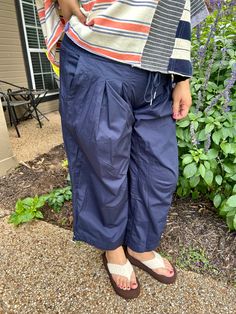 Super relaxed fit navy slightly cropped pants featuring a smocked waist with a pull drawstring closure, two side hip pockets, added pleats for detail, two back pockets and a drawstring cinch cuff on the sides of legs. so super comfy! Anna is 5:7 and weighs 185, she is wearing a large