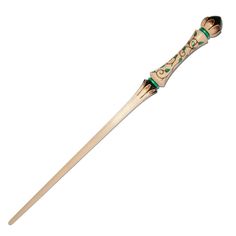 an old fashioned toothbrush with green and gold trimmings on the tip,