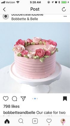 a pink cake sitting on top of a table