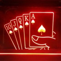 four playing cards are glowing in the dark