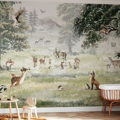 an animal themed wallpaper in a children's room with deers and other animals