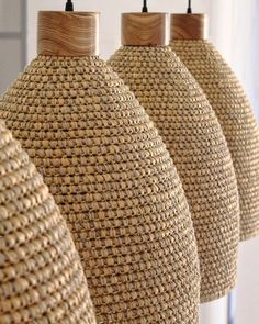 three lamps made out of woven material hanging from the ceiling