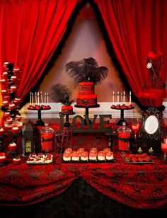 an image of a red and black dessert table