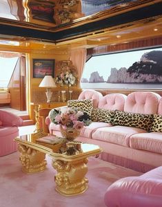 a living room with pink couches and leopard print pillows