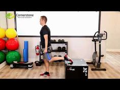 a man is doing exercises on an exercise machine in front of a large screen with colorful balls