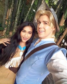 two people dressed up as peter pan and alice mouse in front of some bamboo trees