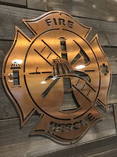 a fire department emblem on the side of a wooden wall in front of a building