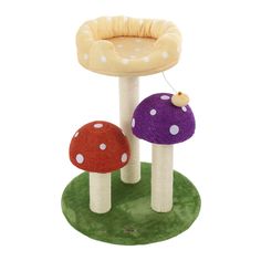 two mushrooms are sitting in front of a mushroom - shaped table with a white polka dot top