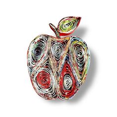 an apple made out of paper with swirls on it