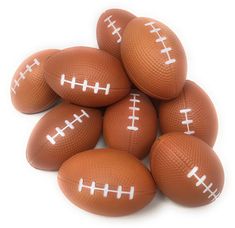 six brown footballs with white stitching on them are stacked up in a pyramid