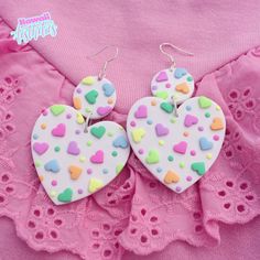 two heart shaped cookies are on top of a pink dress