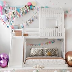 there is a bunk bed in the room with balloons and streamers on the wall