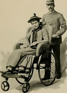 an old black and white photo of a man in uniform standing next to a woman in a wheelchair