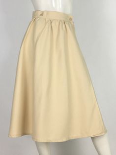 "60s swing skirt, wrap skirt, off white wrap midi skirt  mannequin measures 5ft 8\", bust 34\", waist 25\", hip 33\" Measurements:  waist 13\"/hip 23\"-open/length 28\"/width of bottom 40\" Please note that vintage clothing sizes can vary greatly.  The Measurements provided are taken with garment lying flat.  I suggest taking a similar garment from your wardrobe and measure it while lying flat.  This way you can compare measurements.   Please note buyer is responsible for any duties, taxes or customs clearance fees imposed by their country. Be sure to check in often as new gems are added daily.. **all sales are final." Fitted Beige Maxi Skirt For Daywear, Beige Flowy Lined Wrap Skirt, Flowy Beige Lined Wrap Skirt, Cream Relaxed Fit Skirt For Daywear, Relaxed Fit Cream Midi Maxi Skirt, Beige Midi Skirt For Daywear, Beige Lined Maxi Skirt For Daywear, Beige Midi Wrap Skirt With Lining, Cream Lined Midi Skirt