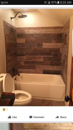 the bathroom is decorated with wood planks on the walls and in the bathtub