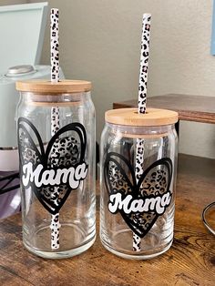 two glass jars with leopard print and the words mama on them are sitting on a table