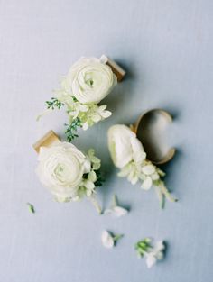 white flowers and wooden spoons on a blue surface