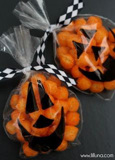 two bags filled with candies and jack - o'- lantern faces on top of each other