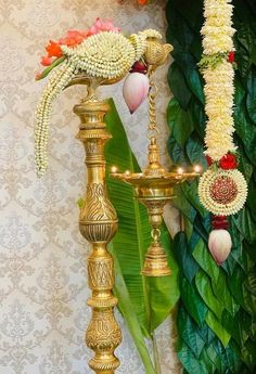 an ornate gold stand with flowers and candles