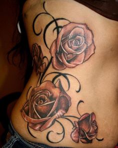 a woman's stomach with two roses on it