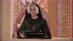 a man in a priest's outfit giving a speech