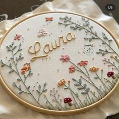 the embroidery is made to look like it has flowers and leaves on it, with the word'dura'written in gold