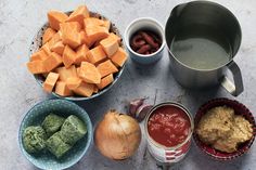 there are many different foods in bowls on the table