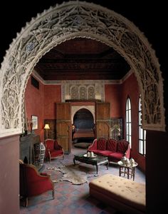 an ornately decorated living room with red couches