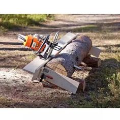 a large log laying on top of a forest floor next to a sawduster