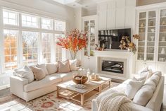 a living room filled with furniture and a fire place in the middle of a room