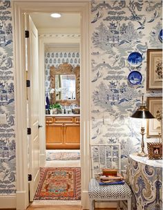 the hallway is decorated with blue and white wallpaper