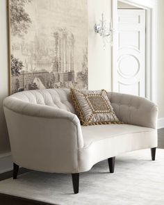 a chair sitting in front of a painting on the wall next to a rug and door