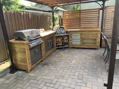 an outdoor bbq with grills, tables and chairs